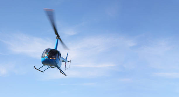 istock The aircraft - Front view Blue small helicopter makes flight low height 1156916746