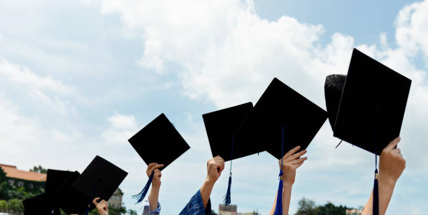 istock Group of graduate students holding their graduation hats 1156916748