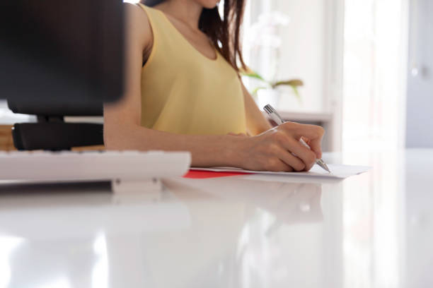 istock Business women writing on document 1156916852