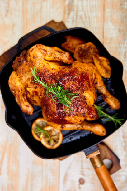 istock Baked whole chicken with apples in pan 1156916860