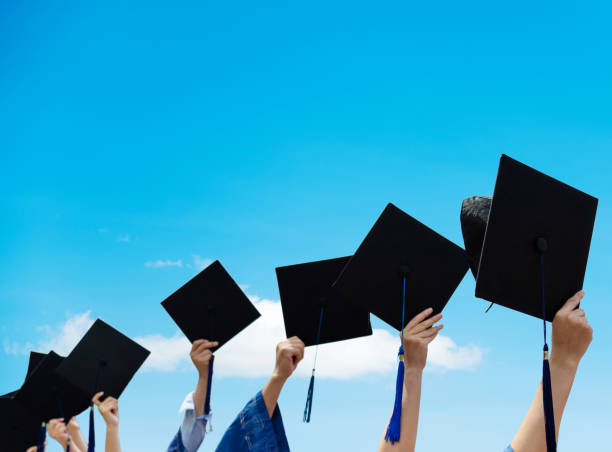 istock Group of graduate students holding their graduation hats 1156916927
