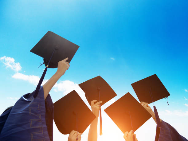 istock Group of graduate students holding their graduation hats 1156916964