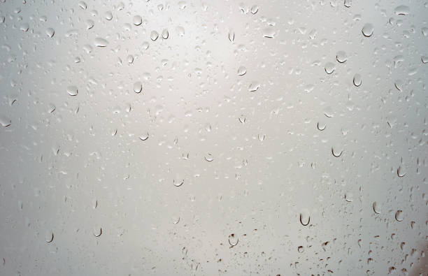 istock Rain drops on a glass window close up 1156916988
