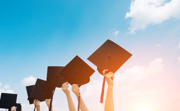 istock Group of graduate students holding their graduation hats 1156917090