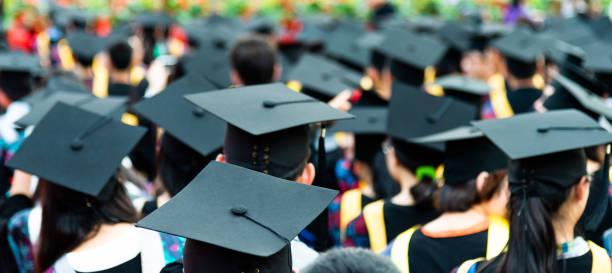 Rear view of graduation caps during commencement.