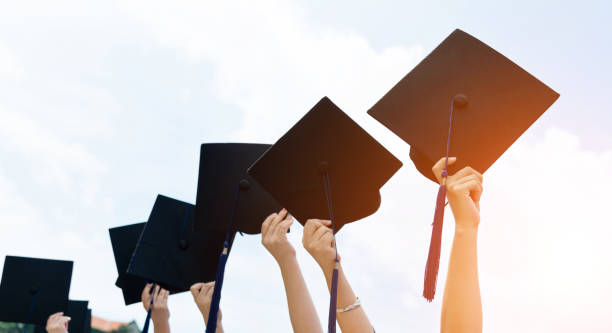 istock Group of graduate students holding their graduation hats 1156917213