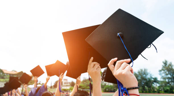 istock Group of graduate students holding their graduation hats 1156917258