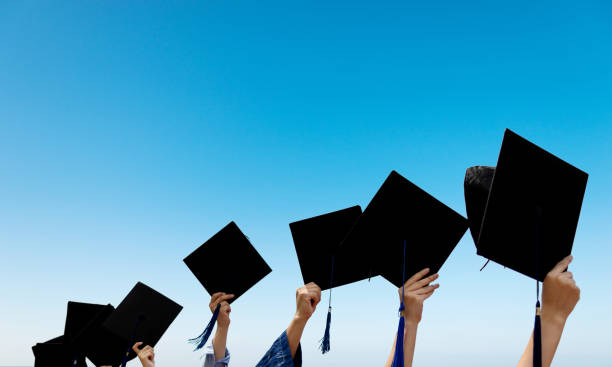 istock Group of graduate students holding their graduation hats 1156917286