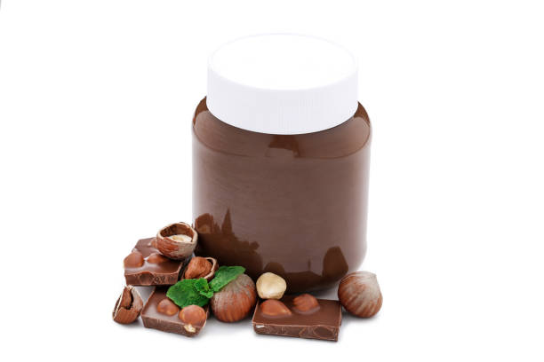 istock Melted chocolate with hazelnuts and mint leafs isolated on white background 1156917363