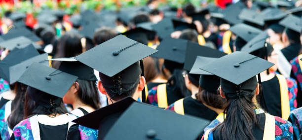 Rear view of graduation caps during commencement.