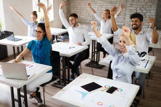 istock Successful happy group of people learning software engineering and business during presentation 1156917590