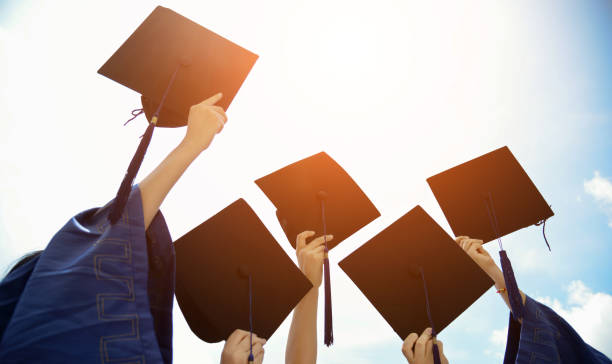 istock Group of graduate students holding their graduation hats 1156917599