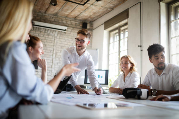 istock Successful happy group of people learning software engineering and business during presentation 1156918380