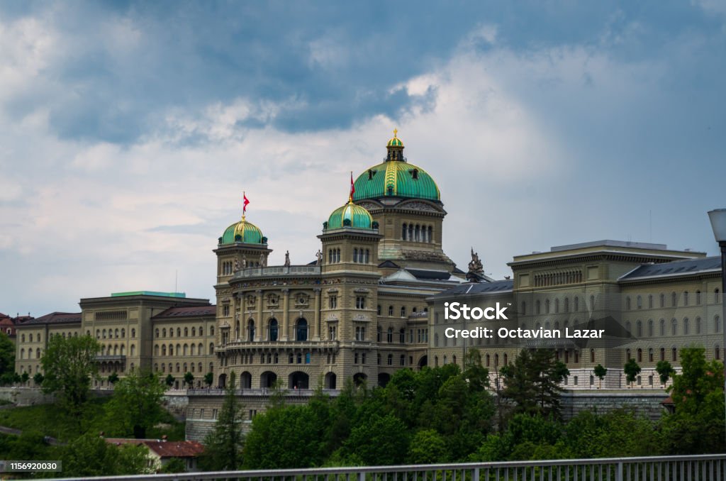 Parliament building in Bern city Switzerland overcast day dramatic cluds summer Bundeshaus Stock Photo