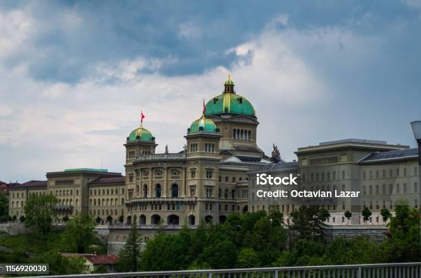 Parliament Building In Bern City Switzerland Overcast Day Dramatic Cluds Summer Stock Photo - Download Image Now