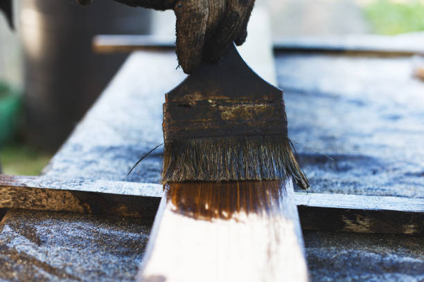 istock a man paints a paint board with a brush 1156920444