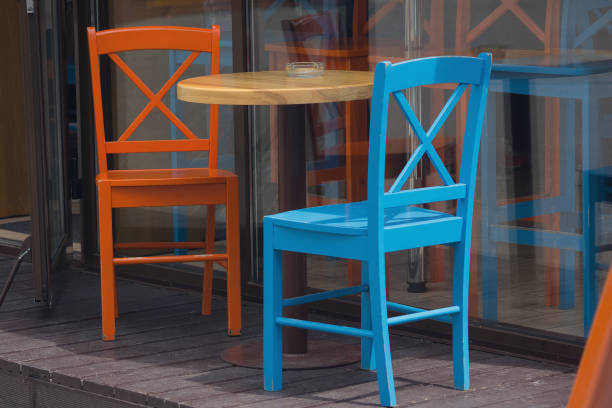 istock Multi-colored little tables and stools on the street 1156920591