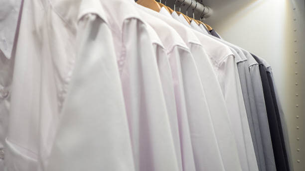 istock Men's shirts on hangers in wardrobe 1156921681