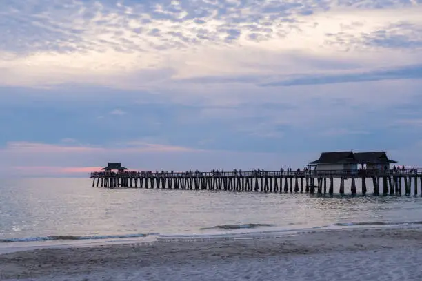 Photo of Naples pier in a purple and pink haze, shot at sunset, Florida, USA