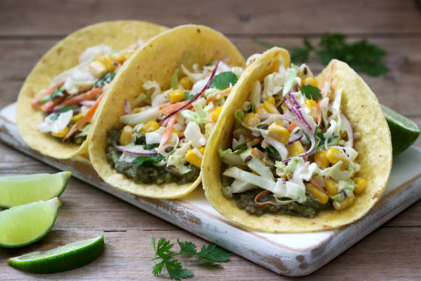 istock Vegetarian tacos stuffed with cabbage salad on a wooden background. Rustic style. 1156925265