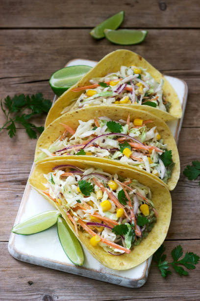 istock Vegetarian tacos stuffed with cabbage salad on a wooden background. Rustic style. 1156925269