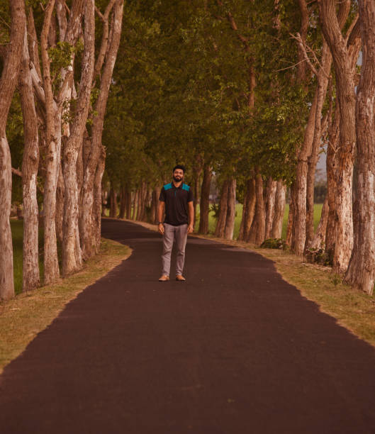 istock Young man standing in an empty road 1156925388
