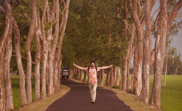 istock Man raising two hands walking in the street 1156925590