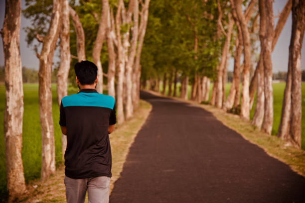 istock Man walking beside an empty street 1156926324