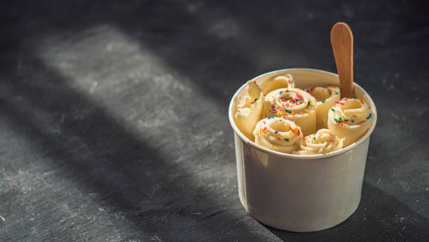 istock Rolled ice cream in cone cup on dark,copy space 1156926496