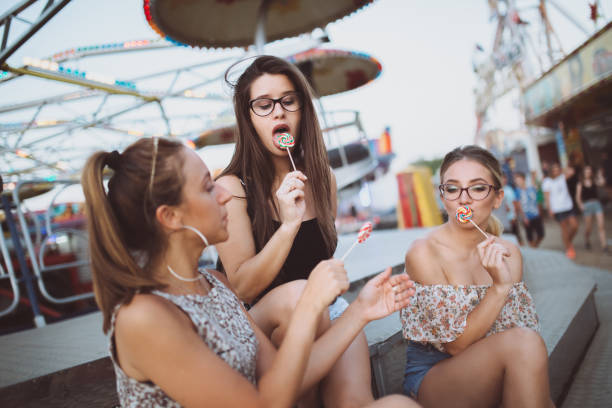 istock Girls fooling around with lollipops 1156927125