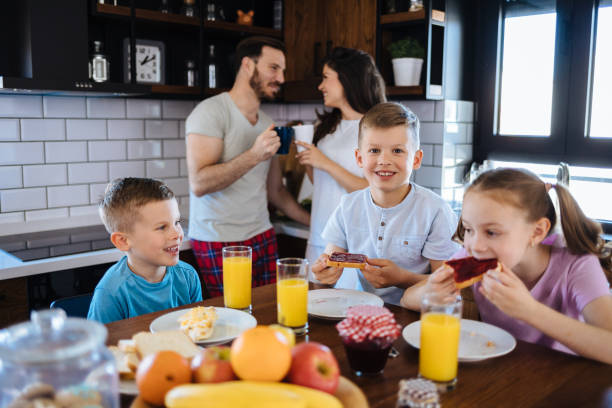 istock Happy family eating breakfast together 1156927827