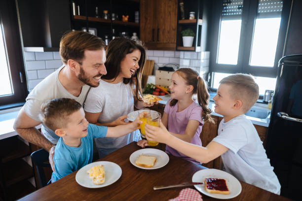 istock Family with three children having breakfast at home 1156928096