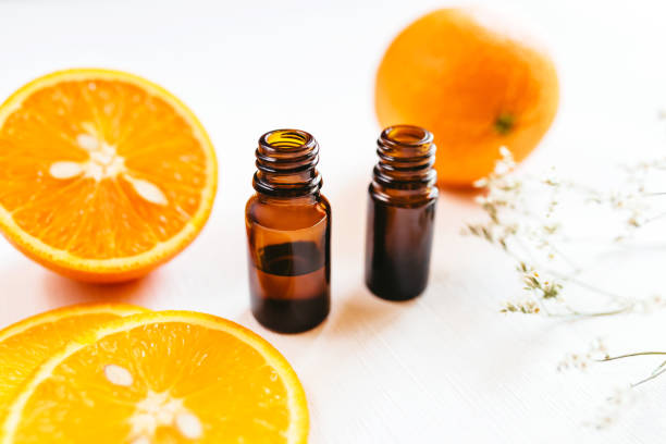 istock Two bottle of orange essential oil on white background 1156928562
