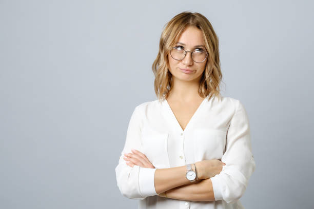 image of thoughtful nervous young woman isolated over gray background - one person people boredom isolated imagens e fotografias de stock