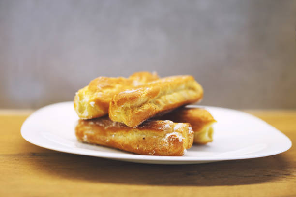 istock eclairs cakes lie on a white plate.  sweet cakes eclairs 1156930845