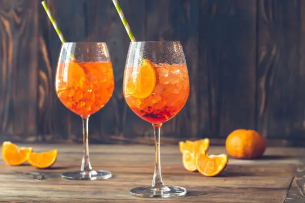 Glasses of Spritz cocktail on the rustic background