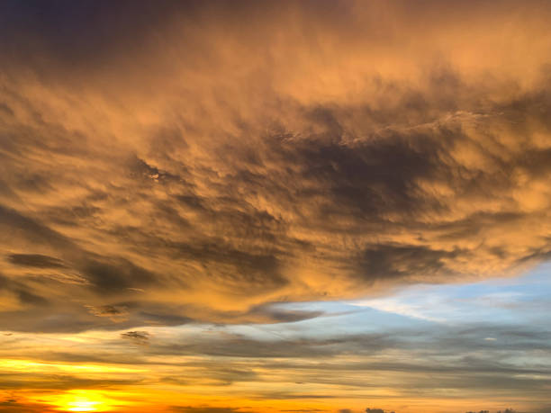 istock Dramatic sky with clouds on gold and red colour. 1156933733