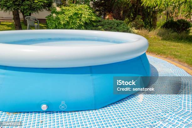 A Round Blue Garden Pool For Children Stock Photo - Download Image Now - Swimming Pool, Inflatable, Yard - Grounds