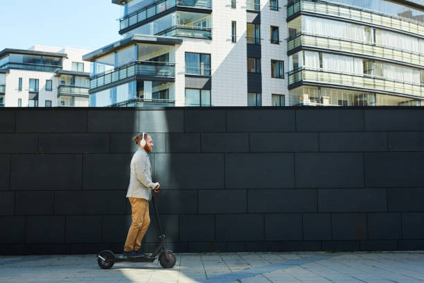 Businessman riding kick scooter