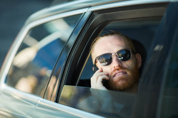 istock Handsome man working inside of taxi car 1156935994