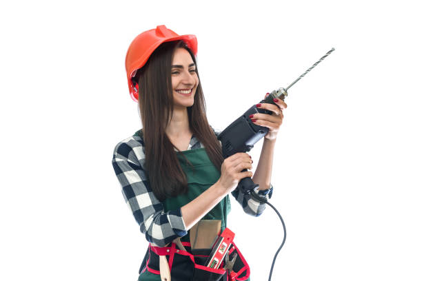 istock Young woman with drill isolated on white 1156936641