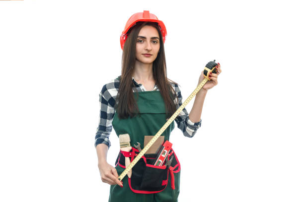 Woman in worker uniform with measuring tape isolated on white