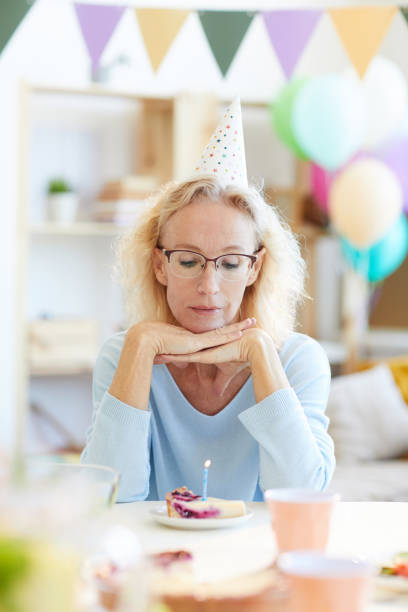 istock Depressed lady in party hat 1156937168