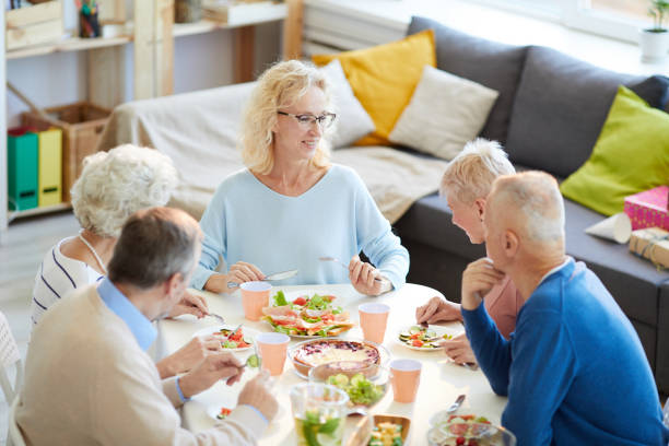 istock Happy woman enjoying dinner with friends 1156937235
