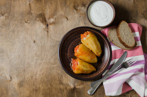 istock Stuffed peppers with rice and minced meat stew in tomatoes, rye bread. Rustic food. 1156938659