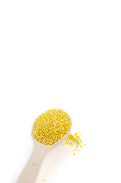 istock Yellow corn grits are in a wooden spoon on a white background 1156938689