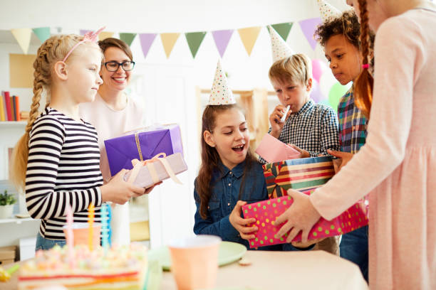 istock Children giving Birthday Presents 1156938982
