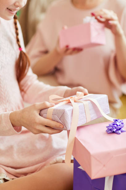 istock Opening Birthday Gifts Closeup 1156938998