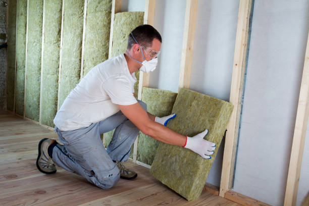 istock Worker in protective goggles and respirator insulating rock wool insulation in wooden frame for future house walls for cold barrier. Comfortable warm home, economy, construction and renovation concept 1156942435