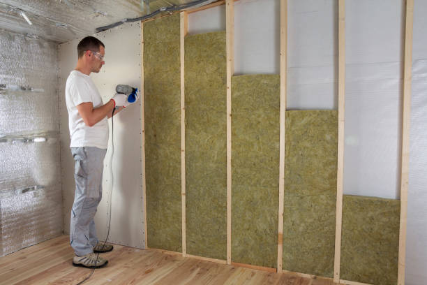 istock Worker in goggles with screwdriver working on insulation. Drywall on wall beams, insulating rock wool staff in wooden frame. Comfortable warm home, economy, construction and renovation concept. 1156942462